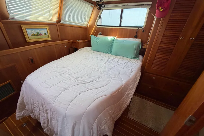 Slide: The Image of Cozy bedroom in 2003 Pacific Seacraft 38T Fast Trawler with wood paneling and natural light. - 144