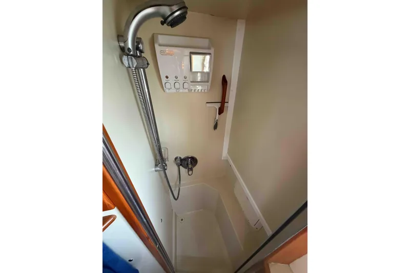 Slide: The Image of Shower area in 2003 Pacific Seacraft 38T Fast Trawler, featuring handheld showerhead and controls. - 136