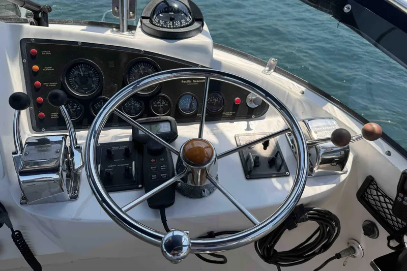 Slide: The Image of Helm of 2003 Pacific Seacraft 38T Fast Trawler with steering wheel and control panel. - 91