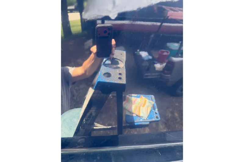 Slide: The Image of Reflection on Pacific Seacraft 38T Fast Trawler, 2003, with person holding phone. - 83