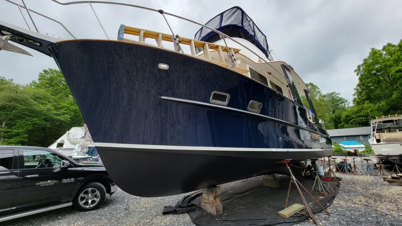 Slide: The Image of A dark blue 2003 Pacific Seacraft 38T Fast Trawler is on a dry dock. - 37