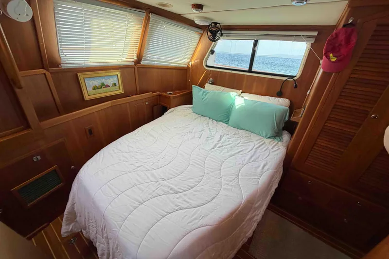 Slide: The Image of Cozy cabin interior of 2003 Pacific Seacraft 38T Fast Trawler with bed and ocean view. - 127