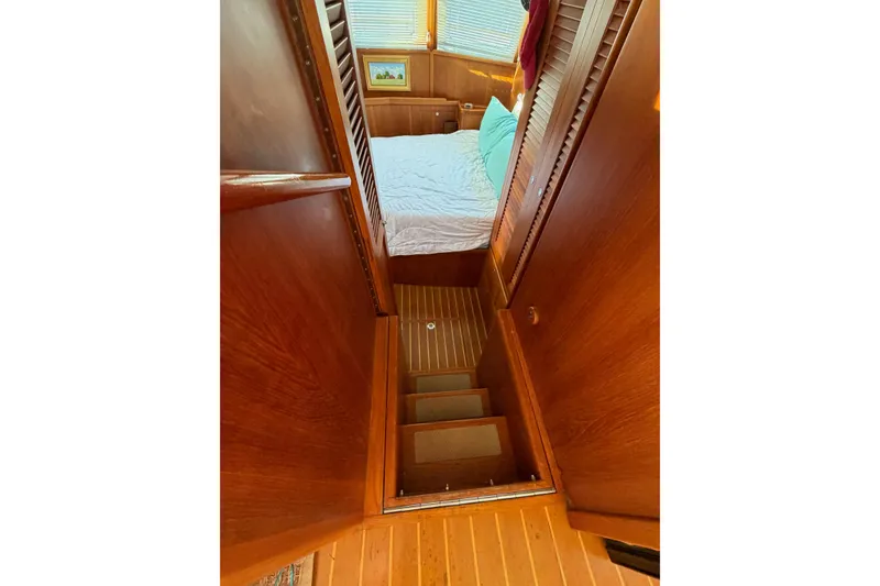 Slide: The Image of Interior of 2003 Pacific Seacraft 38T Fast Trawler with wooden stairs leading to a cozy bedroom. - 132