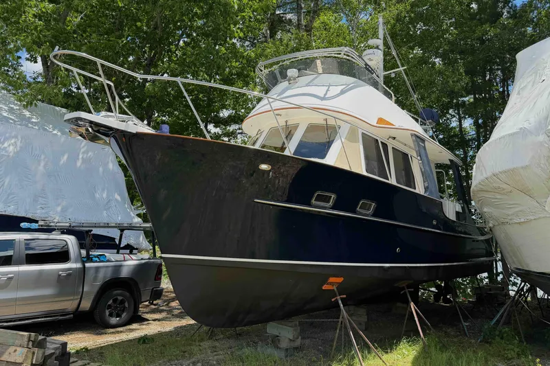 Slide: The Image of 2003 Pacific Seacraft 38T Fast Trawler on land, surrounded by trees and vehicles. - 88