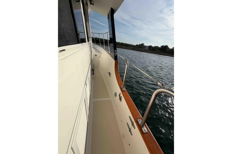 Slide: The Image of Side deck view of 2003 Pacific Seacraft 38T Fast Trawler on calm water. - 125