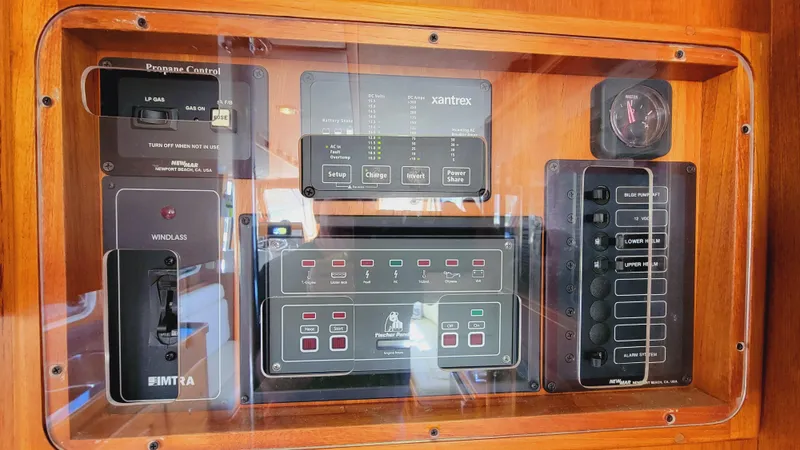 Slide: The Image of A control panel with various switches and displays in a wooden frame. - 27