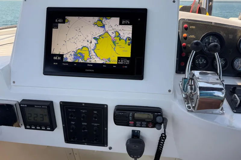 Slide: The Image of Control panel of a 2003 Pacific Seacraft 38T Fast Trawler with navigation and communication equipment. - 98
