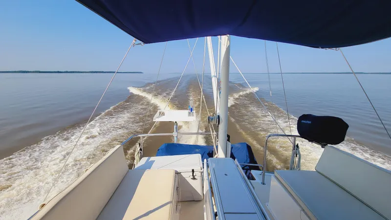 Slide: The Image of The image shows the stern of a 2003 Pacific Seacraft 38T Fast Trawler on calm water. - 4