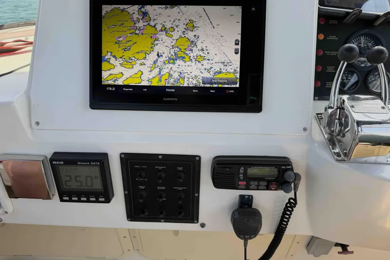 Slide: The Image of Control panel of a 2003 Pacific Seacraft 38T Fast Trawler with navigation equipment. - 90