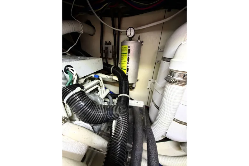 Slide: The Image of Engine room of 2003 Pacific Seacraft 38T Fast Trawler with hoses and gauge. - 152