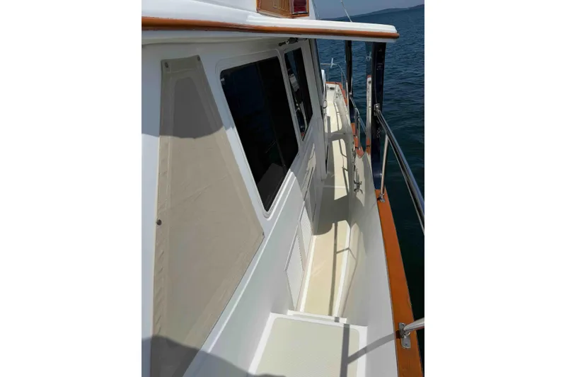 Slide: The Image of Side view of 2003 Pacific Seacraft 38T Fast Trawler on calm water. - 104