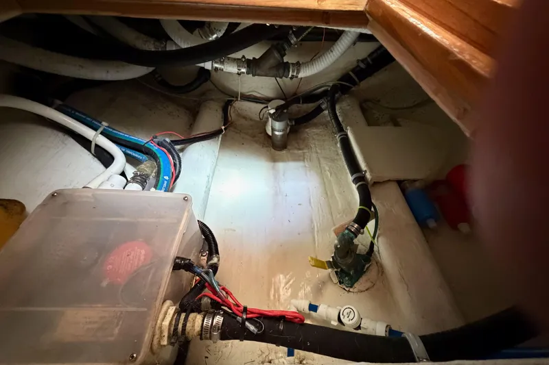 Slide: The Image of Engine room of a 2003 Pacific Seacraft 38T Fast Trawler with visible wiring and plumbing. - 112