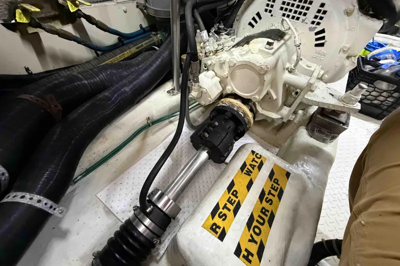 Slide: The Image of Engine room of a 2003 Pacific Seacraft 38T Fast Trawler with visible machinery and caution sign. - 142