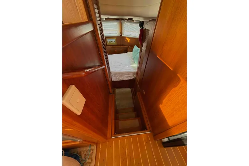 Slide: The Image of Interior of 2003 Pacific Seacraft 38T Fast Trawler with wooden stairs and cozy bedroom. - 129