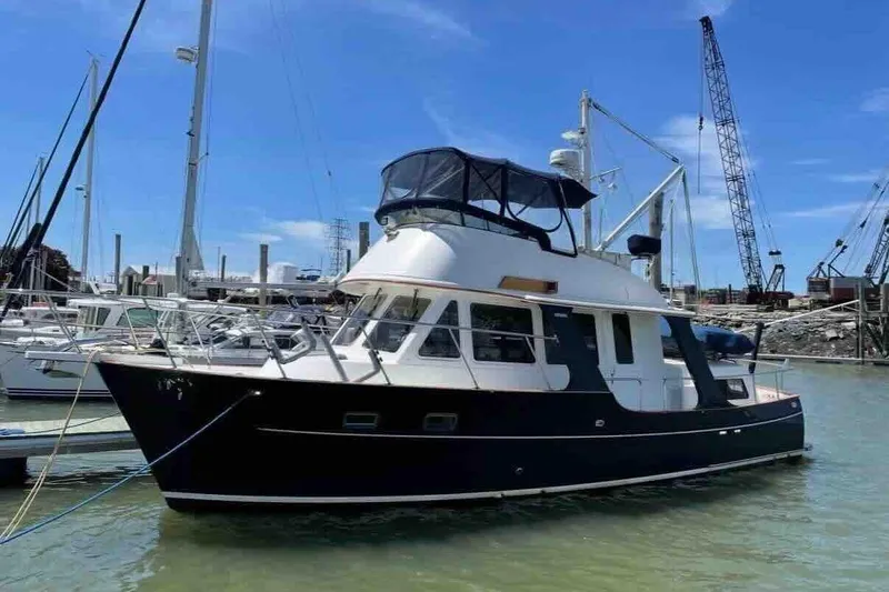 Slide: The Image of 2003 Pacific Seacraft 38T Fast Trawler docked at marina under clear blue sky. - 79