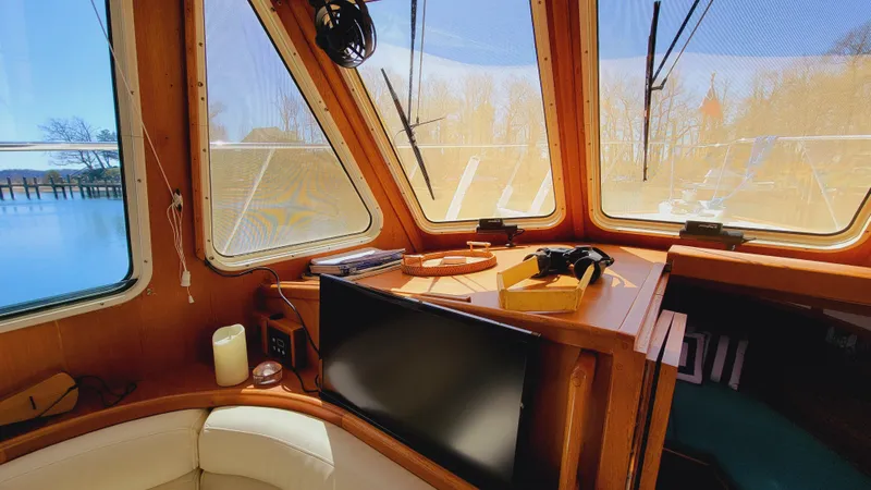 Slide: The Image of Interior view of a boat with large windows, a TV, and a cozy seating area. - 21