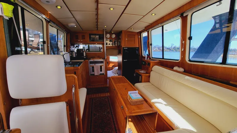 Slide: The Image of Interior of a 2003 Pacific Seacraft 38T Fast Trawler with wooden furnishings and large windows. - 49