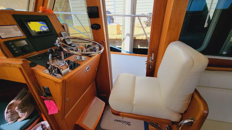 Slide: The Image of Interior view of a boat with a white captain's chair and a helm station with navigation equipment. - 3