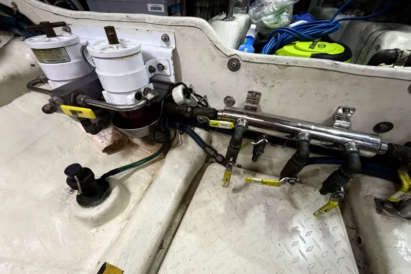 Slide: The Image of Engine compartment of a 2003 Pacific Seacraft 38T Fast Trawler with fuel filters and hoses. - 147
