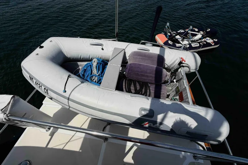 Slide: The Image of Inflatable dinghy on a 2003 Pacific Seacraft 38T Fast Trawler, docked on calm water. - 113