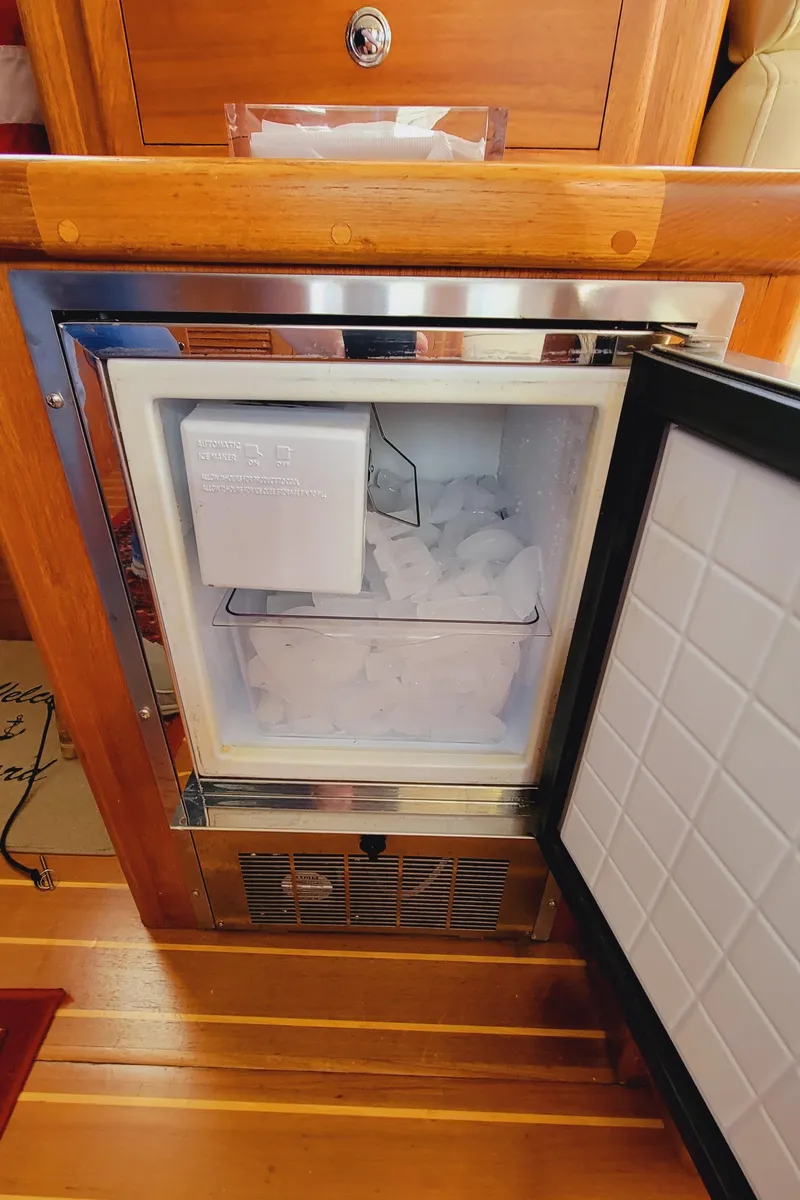 Slide: The Image of An open ice maker in a wooden frame on a boat. - 19
