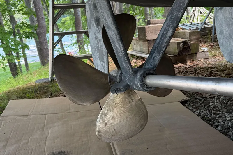 Slide: The Image of Propeller of 2003 Pacific Seacraft 38T Fast Trawler on dry land, surrounded by trees. - 84