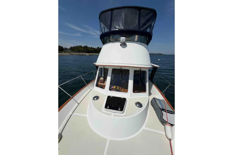 Slide: The Image of 2003 Pacific Seacraft 38T Fast Trawler on calm water, showcasing deck and cabin. - 103