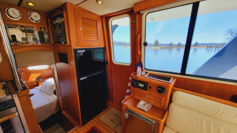 Slide: The Image of Interior of a 2003 Pacific Seacraft 38T Fast Trawler with wood furnishings and a view of the water. - 18