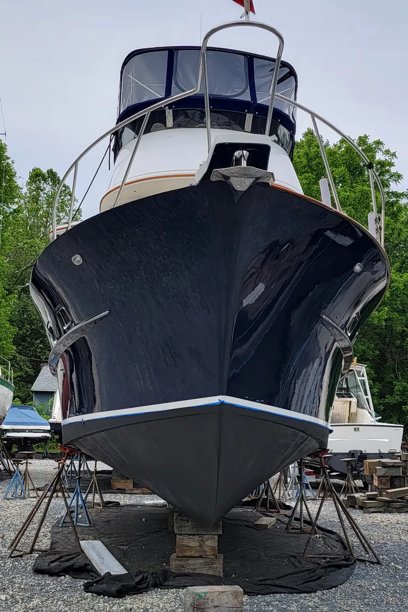 Slide: The Image of A 2003 Pacific Seacraft 38T Fast Trawler on dry dock, surrounded by trees. - 42