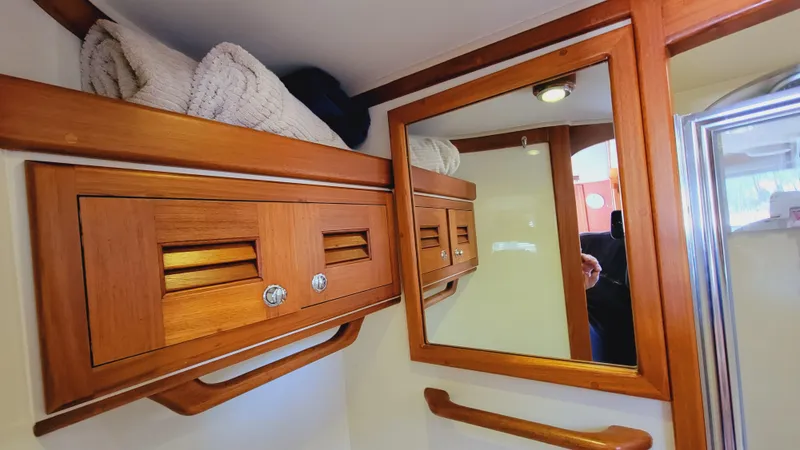 Slide: The Image of A sleek bathroom with wooden cabinets and a mirror on the wall. - 31