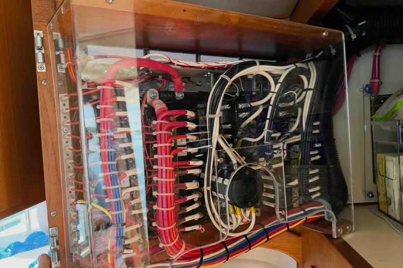 Slide: The Image of Electrical panel inside a 2003 Pacific Seacraft 38T Fast Trawler, showcasing organized wiring. - 96