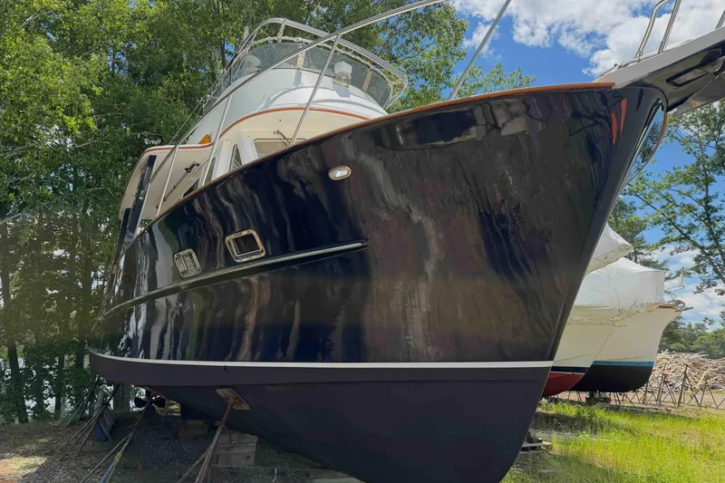 Slide: The Image of 2003 Pacific Seacraft 38T Fast Trawler on land, surrounded by trees and blue sky. - 87