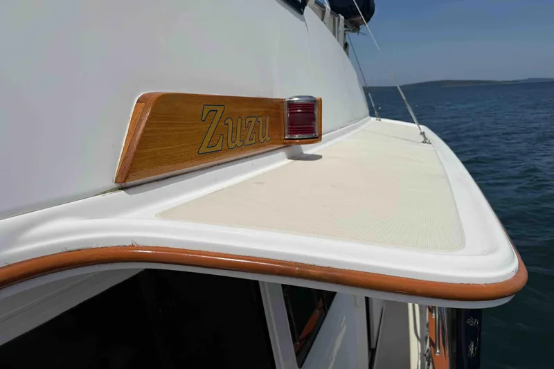 Slide: The Image of 2003 Pacific Seacraft 38T Fast Trawler with wooden trim and nameplate "Zuzu" on deck. - 105