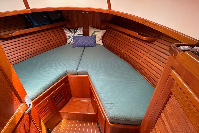Slide: The Image of Cozy cabin interior of 2003 Pacific Seacraft 38T Fast Trawler with wooden finish and cushions. - 110