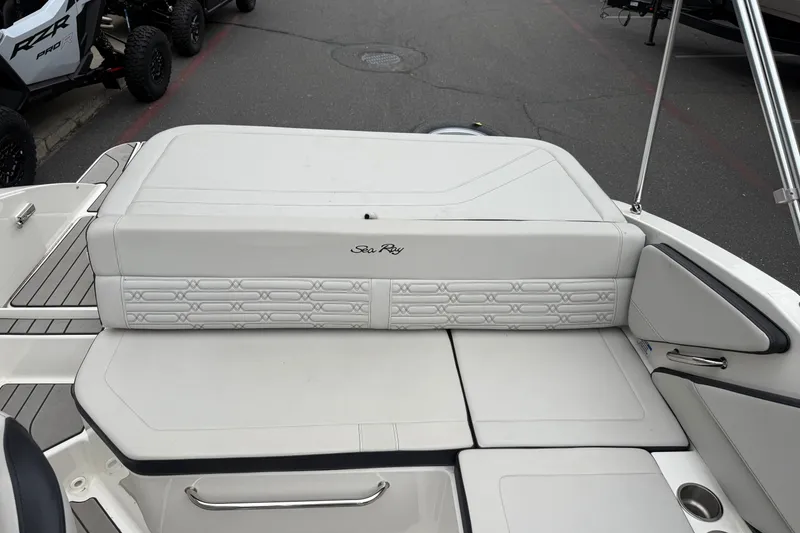 Slide: The Image of 2024 Sea Ray SPX 190 boat interior with white cushioned seating and sleek design. - 16