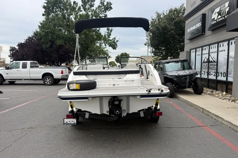 Slide: The Image of 2024 Sea Ray SPX 190 boat parked in a lot, rear view with canopy. - 3