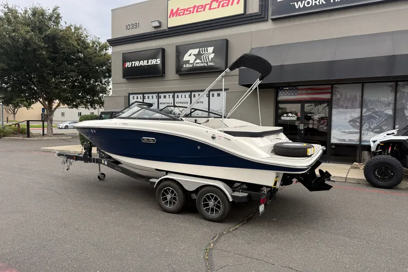 Slide: The Image of 2024 Sea Ray SPX 190 boat on trailer outside dealership. - 2