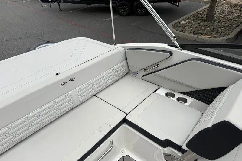 Slide: The Image of 2024 Sea Ray SPX 190 boat interior with white seating and cup holders. - 17