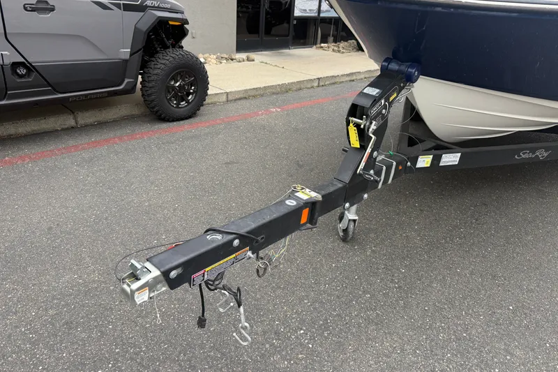 Slide: The Image of Trailer hitch of a 2024 Sea Ray SPX 190 boat parked on asphalt. - 7