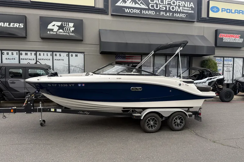 Slide: The Image of 2024 Sea Ray SPX 190 boat on trailer outside dealership. - 1