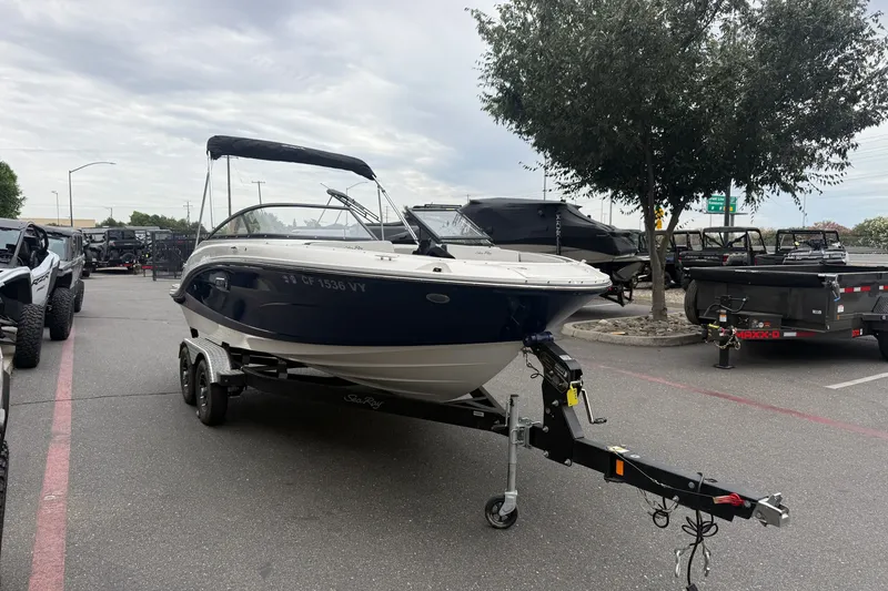 Slide: The Image of 2024 Sea Ray SPX 190 boat on trailer in parking lot, overcast sky. - 5