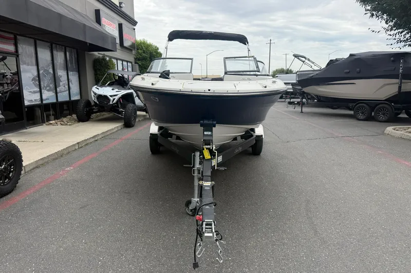 Slide: The Image of 2024 Sea Ray SPX 190 boat on trailer in dealership parking lot. - 6