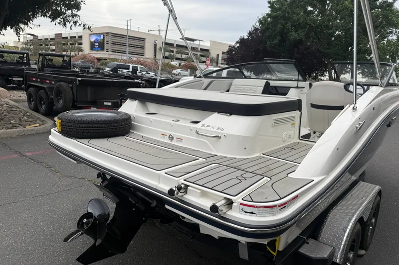 Slide: The Image of 2024 Sea Ray SPX 190 boat on trailer, showcasing sleek design and spacious seating. - 12