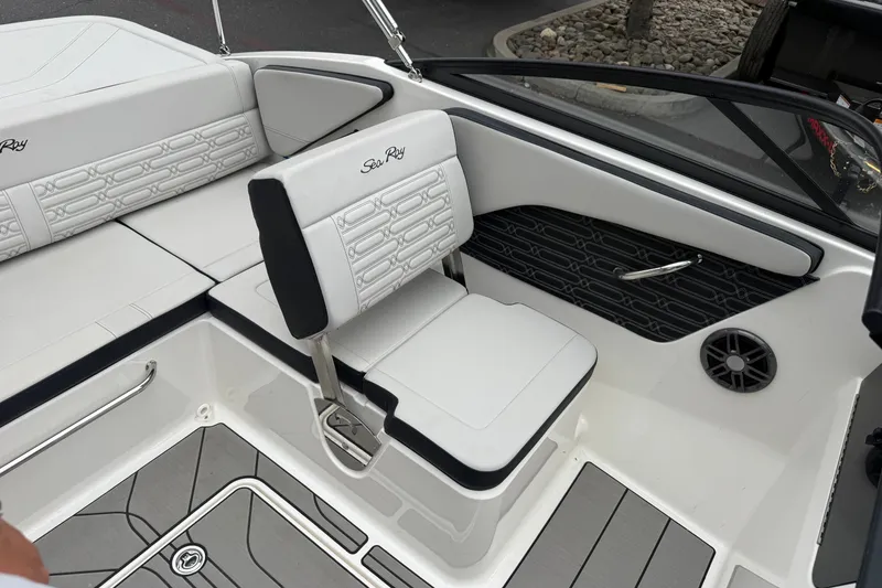 Slide: The Image of 2024 Sea Ray SPX 190 boat interior with white seating and modern design. - 19