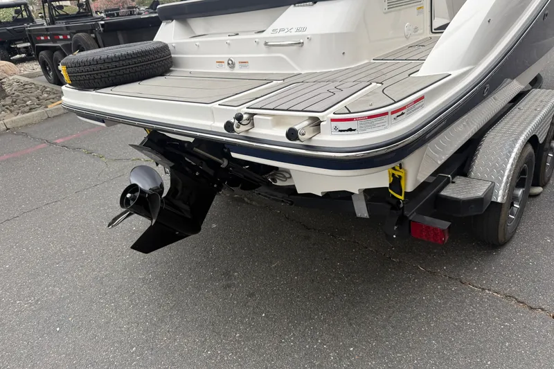 Slide: The Image of 2024 Sea Ray SPX 190 boat rear view with propeller and trailer. - 10