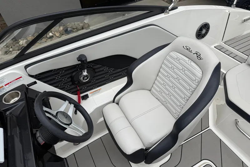 Slide: The Image of 2024 Sea Ray SPX 190 boat interior with steering wheel and branded seat. - 14