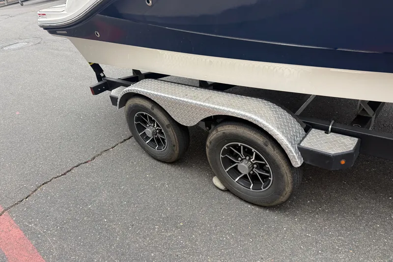 Slide: The Image of Trailer of 2024 Sea Ray SPX 190 boat with dual wheels on asphalt. - 9
