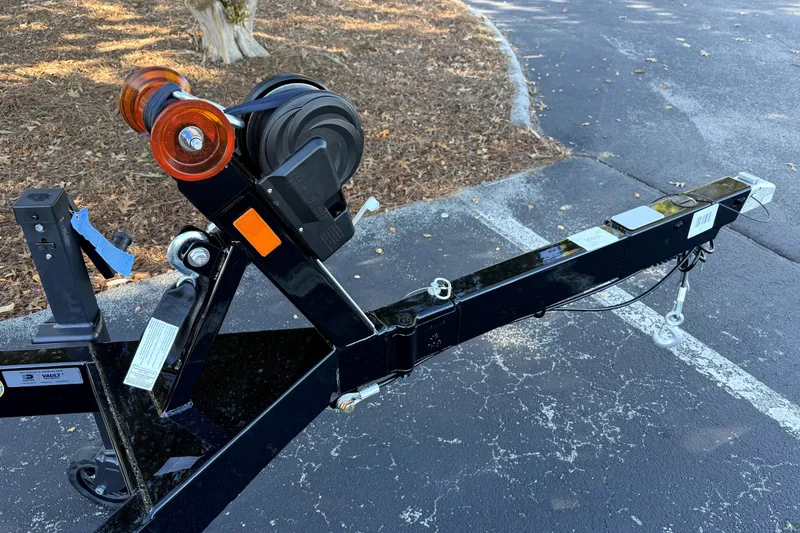 Slide: The Image of Trailer hitch of a 2017 MasterCraft X23 boat on a paved surface. - 47