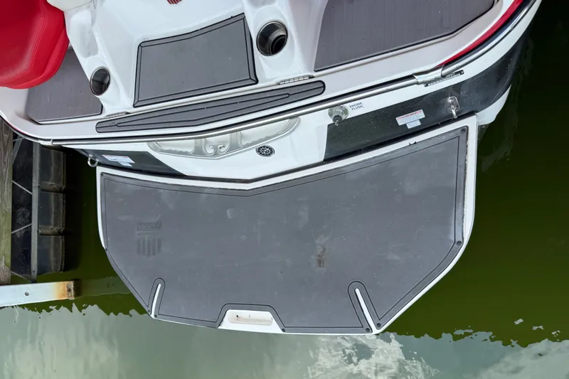 Slide: The Image of 2017 MasterCraft X23 boat stern with swim platform and red seating. - 42