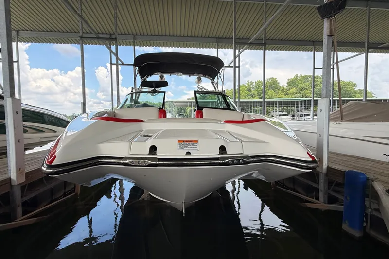 Slide: The Image of 2017 MasterCraft X23 boat docked under a covered marina, showcasing sleek design and red accents. - 19